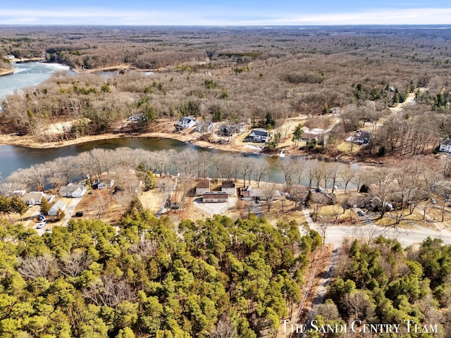 aerial view with a wooded view and a water view