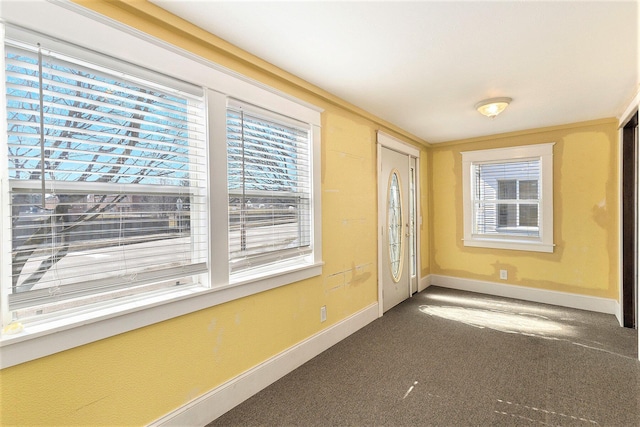 interior space featuring a healthy amount of sunlight and baseboards