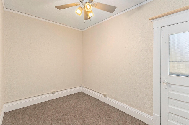 empty room featuring a ceiling fan, baseboards, dark carpet, and ornamental molding