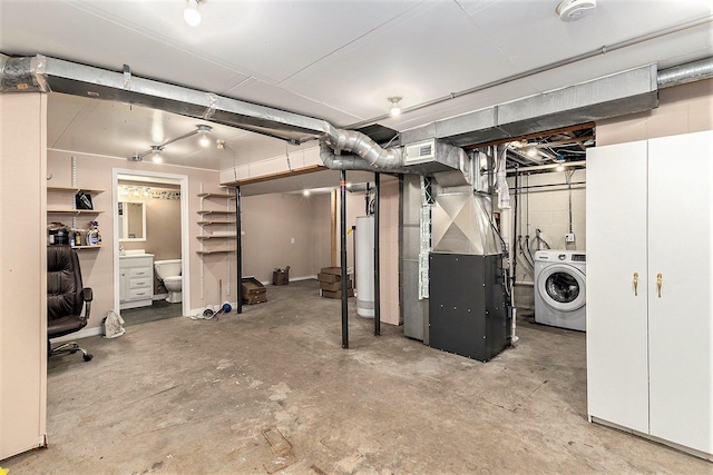 unfinished basement featuring washer / dryer, heating unit, visible vents, and water heater