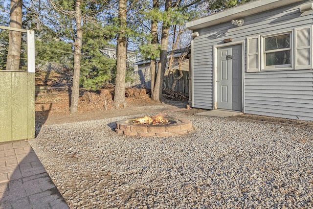 view of yard featuring fence and an outdoor fire pit