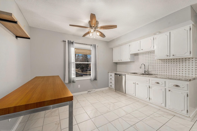 kitchen with visible vents, ceiling fan, dishwasher, decorative backsplash, and a sink