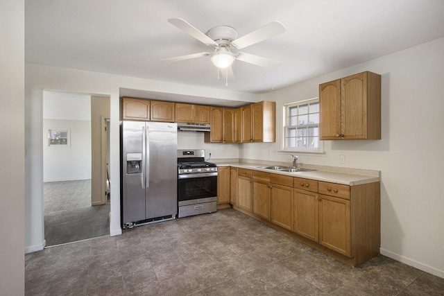 kitchen featuring under cabinet range hood, light countertops, stainless steel appliances, a ceiling fan, and a sink