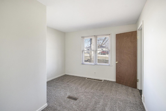 carpeted empty room with baseboards and visible vents