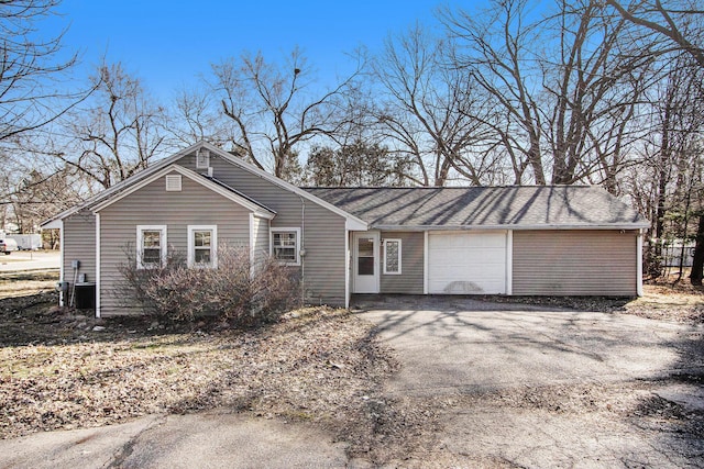 view of front of home featuring a garage and aphalt driveway