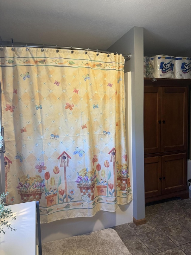 bathroom featuring tile patterned floors and shower / bathtub combination with curtain