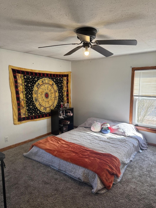 bedroom with carpet flooring, ceiling fan, a textured ceiling, and baseboards