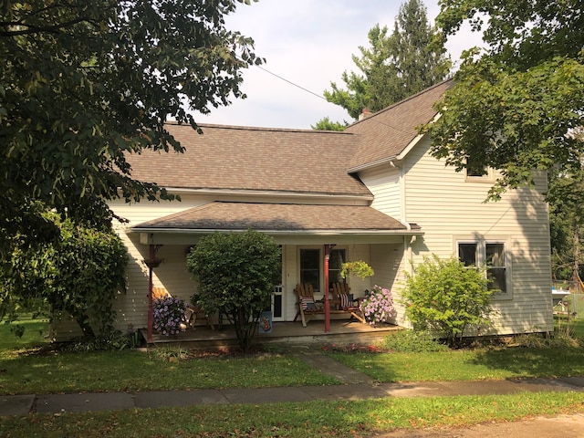 view of front facade featuring covered porch and roof with shingles