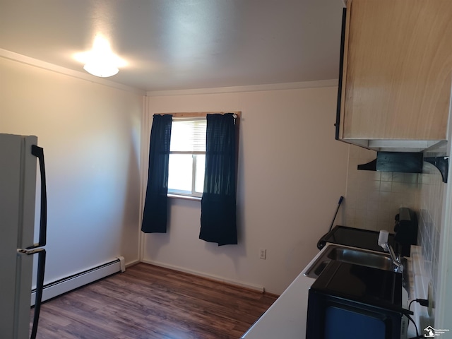 kitchen featuring wood finished floors, freestanding refrigerator, crown molding, baseboards, and baseboard heating