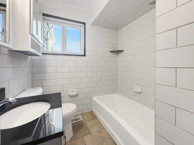 bathroom featuring visible vents, vanity, toilet, and tile walls