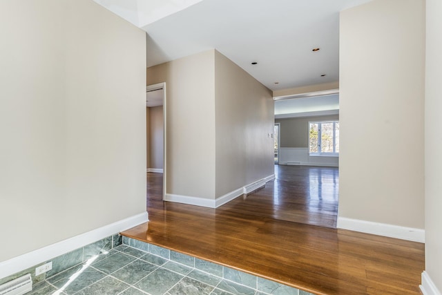 hall with wood finished floors and baseboards