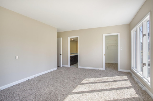 empty room with baseboards and carpet floors