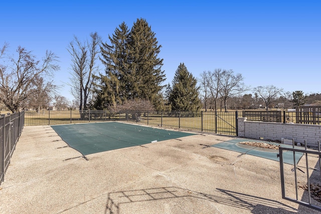 view of swimming pool featuring a patio area and fence