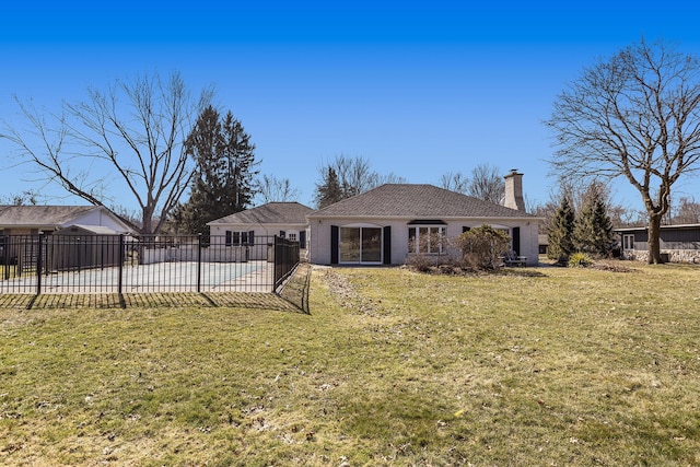 rear view of property featuring a patio, a chimney, a yard, and fence