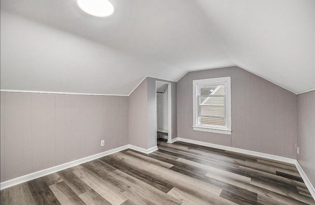 bonus room featuring vaulted ceiling, wood finished floors, and baseboards