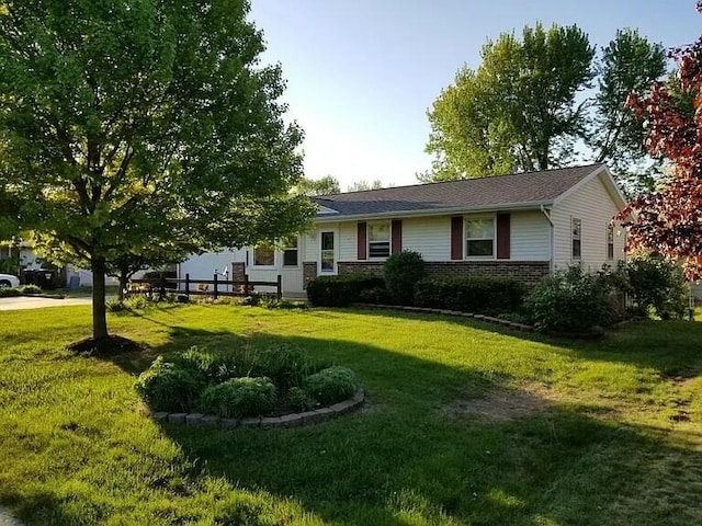 single story home with brick siding and a front lawn