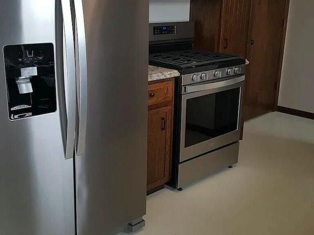 kitchen with brown cabinets and appliances with stainless steel finishes