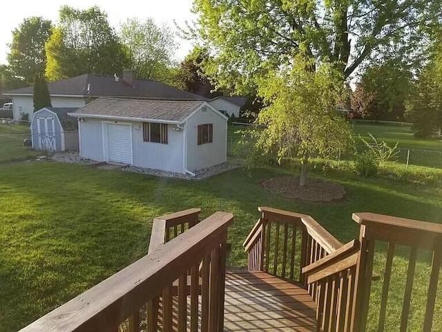 view of yard featuring a deck, an outdoor structure, and fence