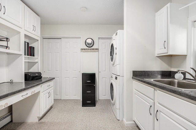 washroom featuring a sink and stacked washer and clothes dryer