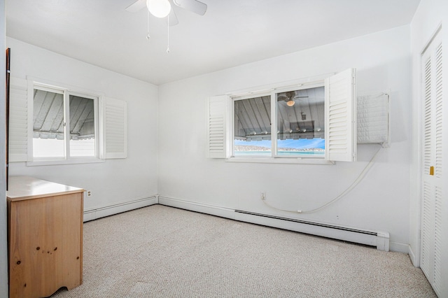 unfurnished bedroom featuring a baseboard heating unit and carpet flooring