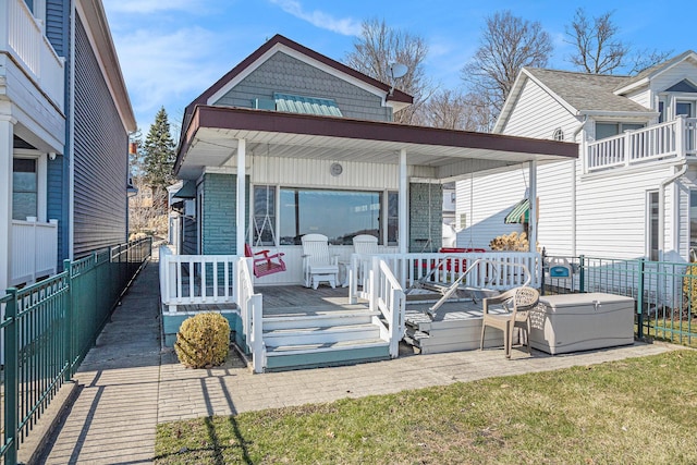 exterior space featuring fence and covered porch