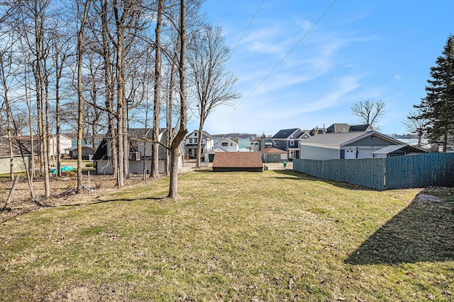 view of yard with a residential view and fence