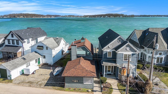 drone / aerial view with a residential view and a water view