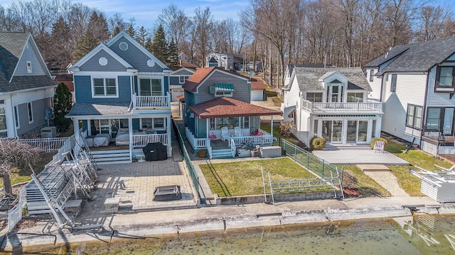 back of property with a patio area, a yard, a fenced backyard, and a balcony