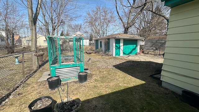 exterior space featuring a detached garage, an outdoor structure, and fence