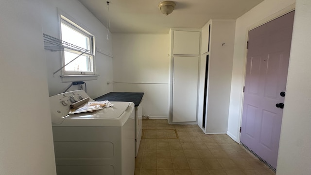 clothes washing area with light floors and washer / clothes dryer