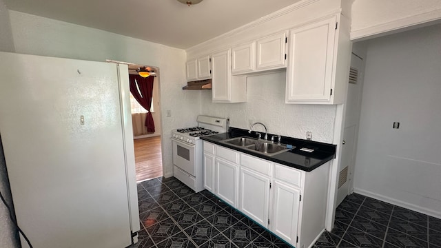 kitchen featuring white cabinetry, white appliances, under cabinet range hood, and a sink