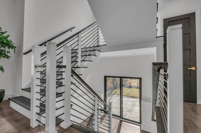 stairs featuring wood finished floors