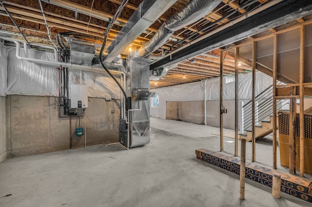 basement with water heater, stairway, and heating unit