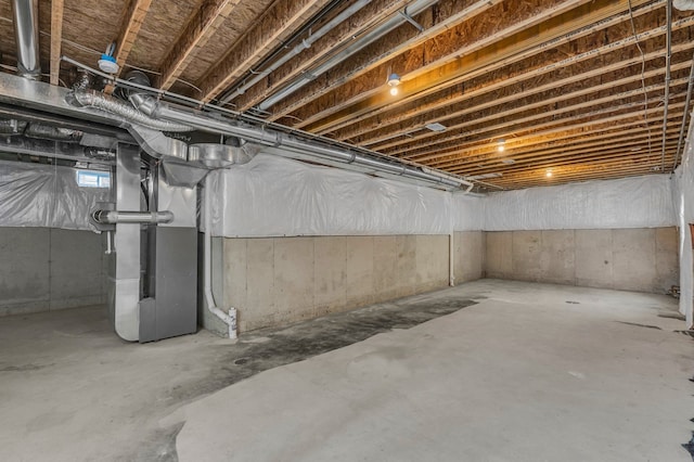 unfinished basement featuring heating unit