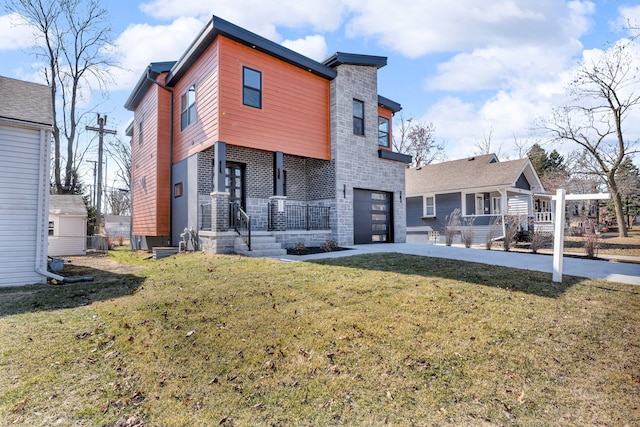 rear view of house with a lawn and an attached garage