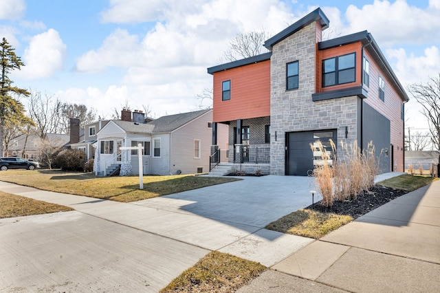 contemporary home featuring stone siding, driveway, an attached garage, and a front lawn