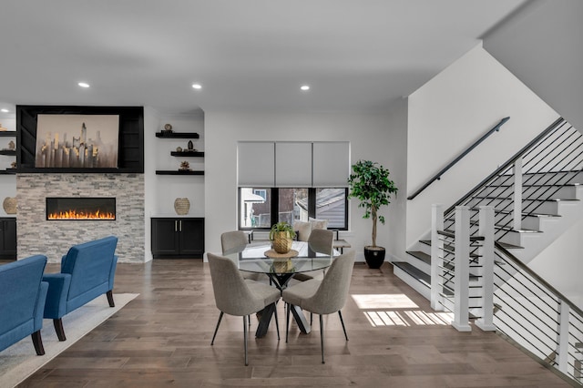 dining area featuring a fireplace, stairway, recessed lighting, and dark wood-style flooring