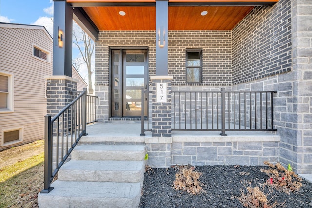 property entrance featuring brick siding