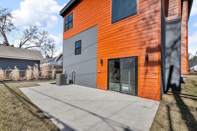 back of house with cooling unit, a patio, and fence