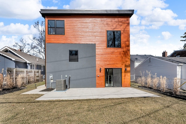 rear view of house with a yard, cooling unit, a patio, and fence