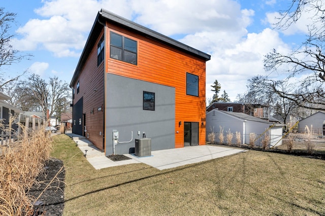 rear view of property featuring central air condition unit, fence, a yard, and a patio area