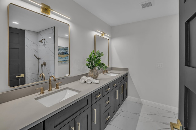 bathroom with baseboards, visible vents, marble finish floor, and a sink