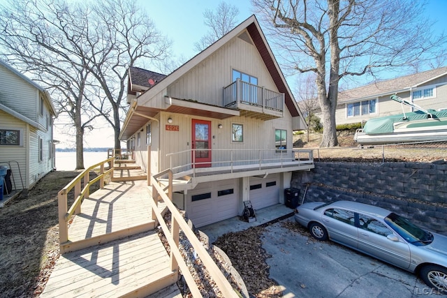 rustic home with a garage, a balcony, and a shingled roof