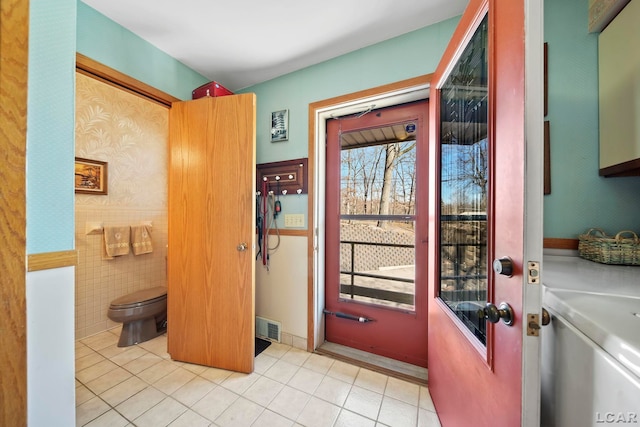 doorway featuring tile patterned flooring and visible vents