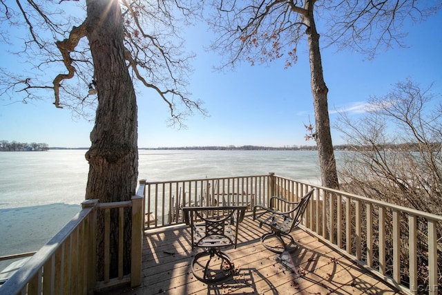 wooden terrace featuring a water view