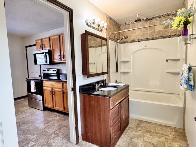 full bathroom with a textured ceiling, bathtub / shower combination, and vanity