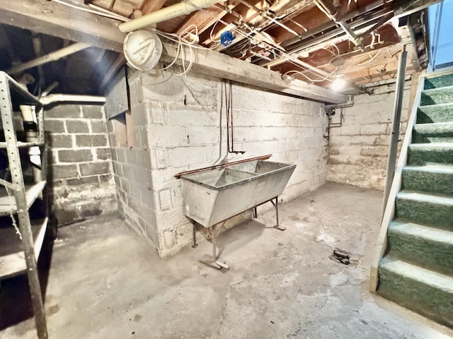 unfinished basement featuring stairs