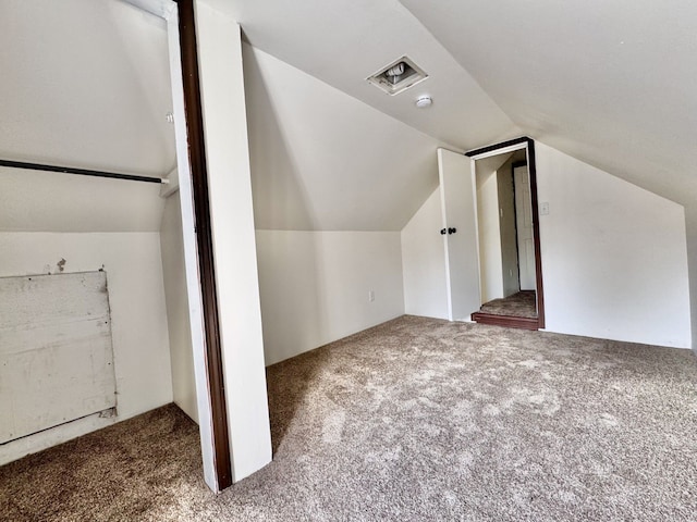 bonus room featuring vaulted ceiling and carpet floors