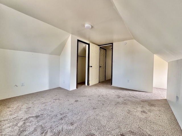 bonus room with carpet floors and lofted ceiling