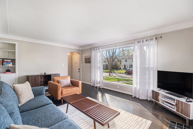 3018 Guilford Dr, Royal Oak, MI 48073 - living room featuring arched walkways, wood finished floors, baseboards, and crown molding